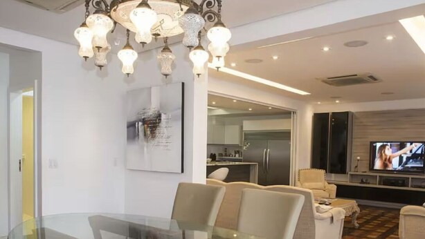 A modern living room with a glass dining table, beige sofas, and a television. - ROCK IN RIO 2026 PROMO Sep 5th to 14th
Best Location Best Living in Rio. (Rio de Janeiro)