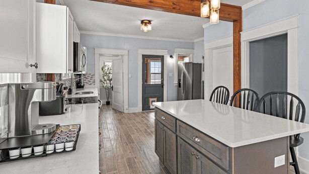 A kitchen with a large island, stainless steel appliances, and a wooden ceiling beam. - 6 Min to Ark! Accommodates 17! (Williamstown)