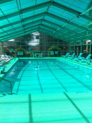 An indoor swimming pool with a covered roof, multiple lanes, and lounge chairs around the perimeter. - Best Little Secret in Myrtle Beach, 2 Bedroom 2 Bath Condo Ground Floor Unit (Myrtle Beach)