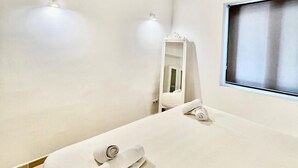 A hotel room with a neatly made bed, a mirror, and a window with a view. - Son Carrió 6, Son Carrió 6 - Sa Perdiu 6 (Son Carrió)