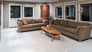A living room with two sofas, a coffee table, and a rug.