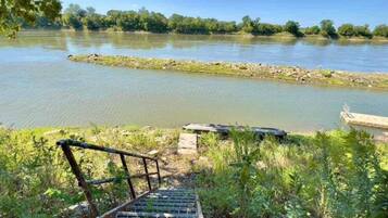 A river with a wooden staircase leading down to the water.