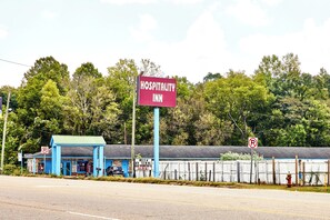 A blue building with a sign reading "Hospitality Inn" and a "No Parking" sign. - Hospitality Inn by Hotel O Selma US 80 (Selma)
