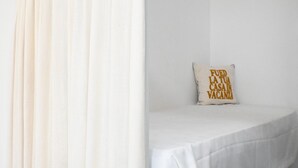 Un lit blanc avec un oreiller sur lequel on peut lire : « FOED LATUA CASA IN VACANZA. »