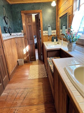 Une salle de bain en bois avec une porte en bois, un lavabo et un miroir.