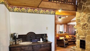 A rustic interior with a wooden vanity, stone walls, and a cozy living area with a fireplace. - Rustic but elegant 4-bedroom farmhouse in Canton with WiFi and AC (Canton)