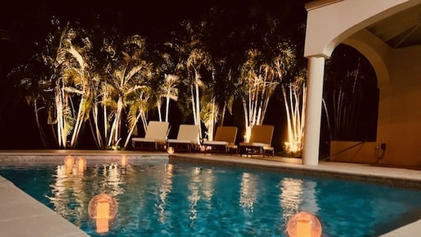 A swimming pool with clear water, surrounded by lounge chairs and palm trees. - The Cove Hotel St.Croix  (Christiansted)