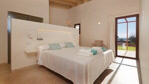 A bedroom with a bed, a chair, a window, and a view of the outdoors. - Rural House 'Son Rossinyol Nou - Ses Figueretes' with Mountain Views, Private Pool and Wi-Fi (Illes Balears)