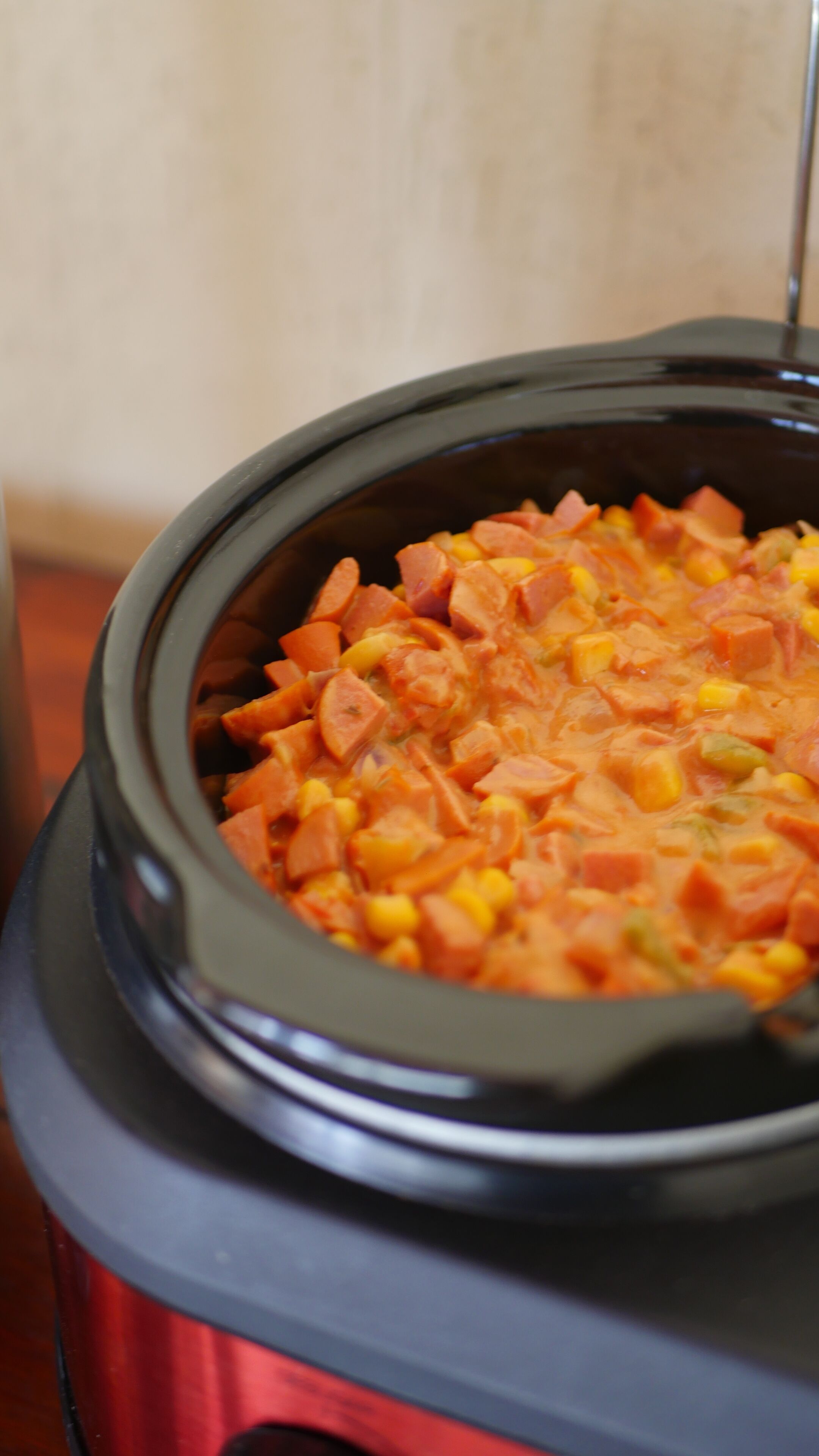 A slow cooker filled with a stew containing chunks of meat and vegetables.