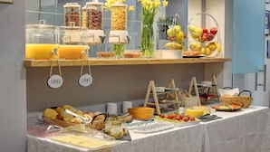 A buffet setup with various food items and beverages.