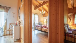 A wooden interior with a bed, a small table, and a chair. - Le Coeur by Interhome (Ovronnaz)