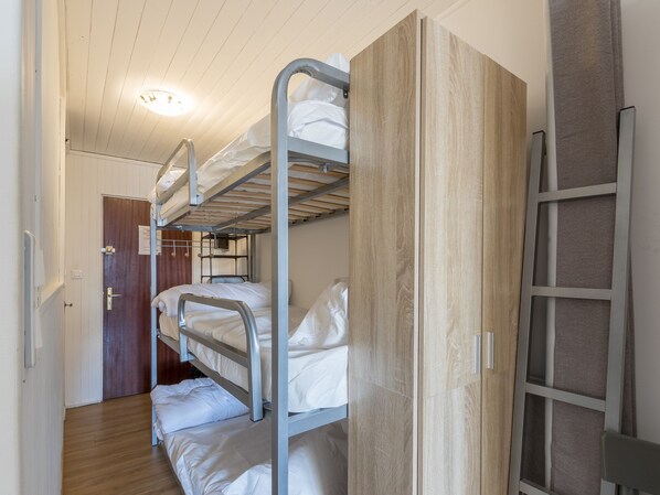 A bunk bed room with a wooden wardrobe and a metal ladder. - Studio cabin, sleeps 4/5 (Orcières)