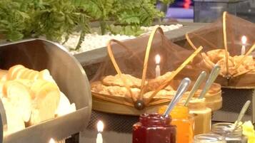 A buffet setup with various food items and condiments.
