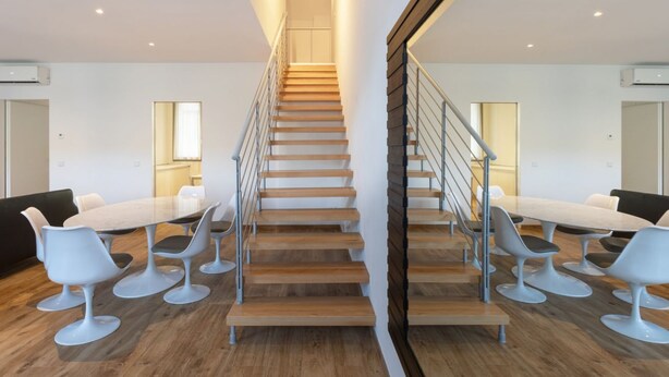 A modern interior with a central staircase, wooden flooring, and contemporary seating areas. - Beautiful two bedrooms Navigli - Mirable PM (Milano)