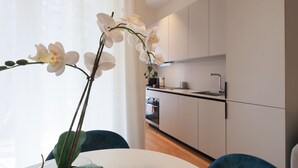 A modern kitchen with white cabinets, a stainless steel sink, and a built-in oven. - One bedroom San'Agostino - Mirable PM (Milano)
