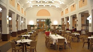 A spacious dining hall with multiple tables and chairs, high ceilings, and large windows. - Masarykova Kolej (Prague)