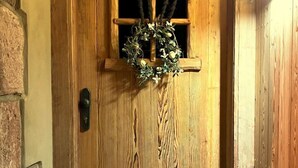 A wooden door with a wreath, a welcome mat, and a window with a wooden frame. - Vidochov by Interhome (Nova Paka)