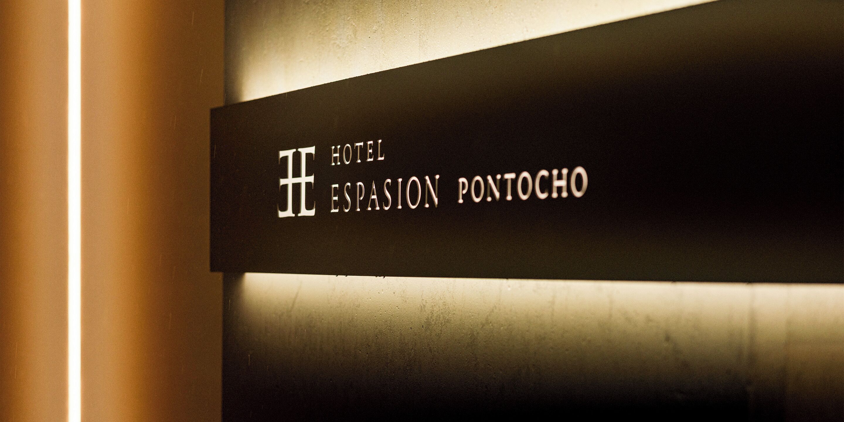 A sign for Hotel Espasion Pontocho with a modern design.