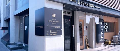 The exterior of Hotel Espasion in Pontocho, featuring a modern facade, entrance signage, and a visible bar area.