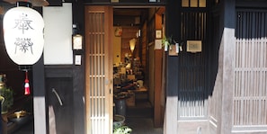 A traditional Japanese shop with a wooden exterior and a visible entrance.
