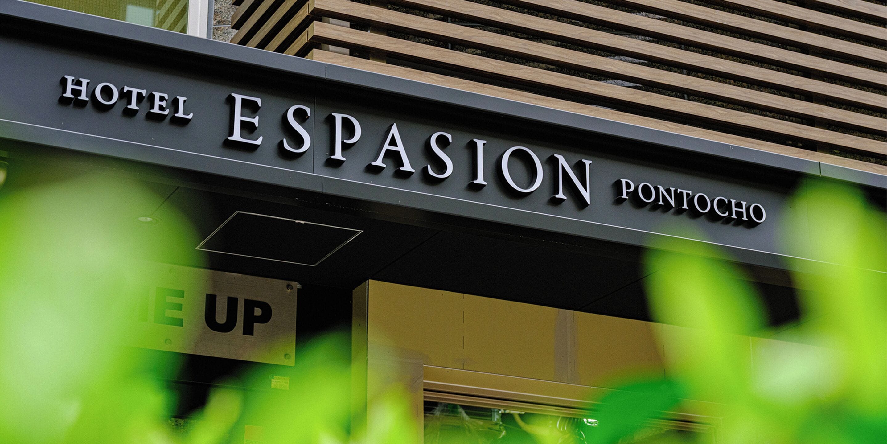 A hotel sign with the name "Hotel Espasion Pontocho".
