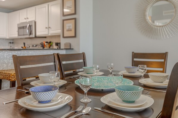 A dining table set with plates, bowls, and cutlery.
