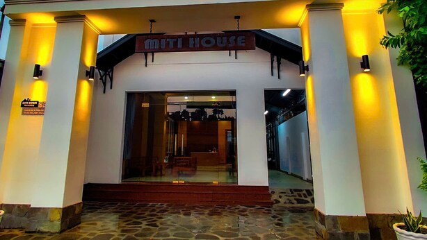 The entrance to a building with a sign reading "MITI HOUSE". - MITI House (Ha Tien)