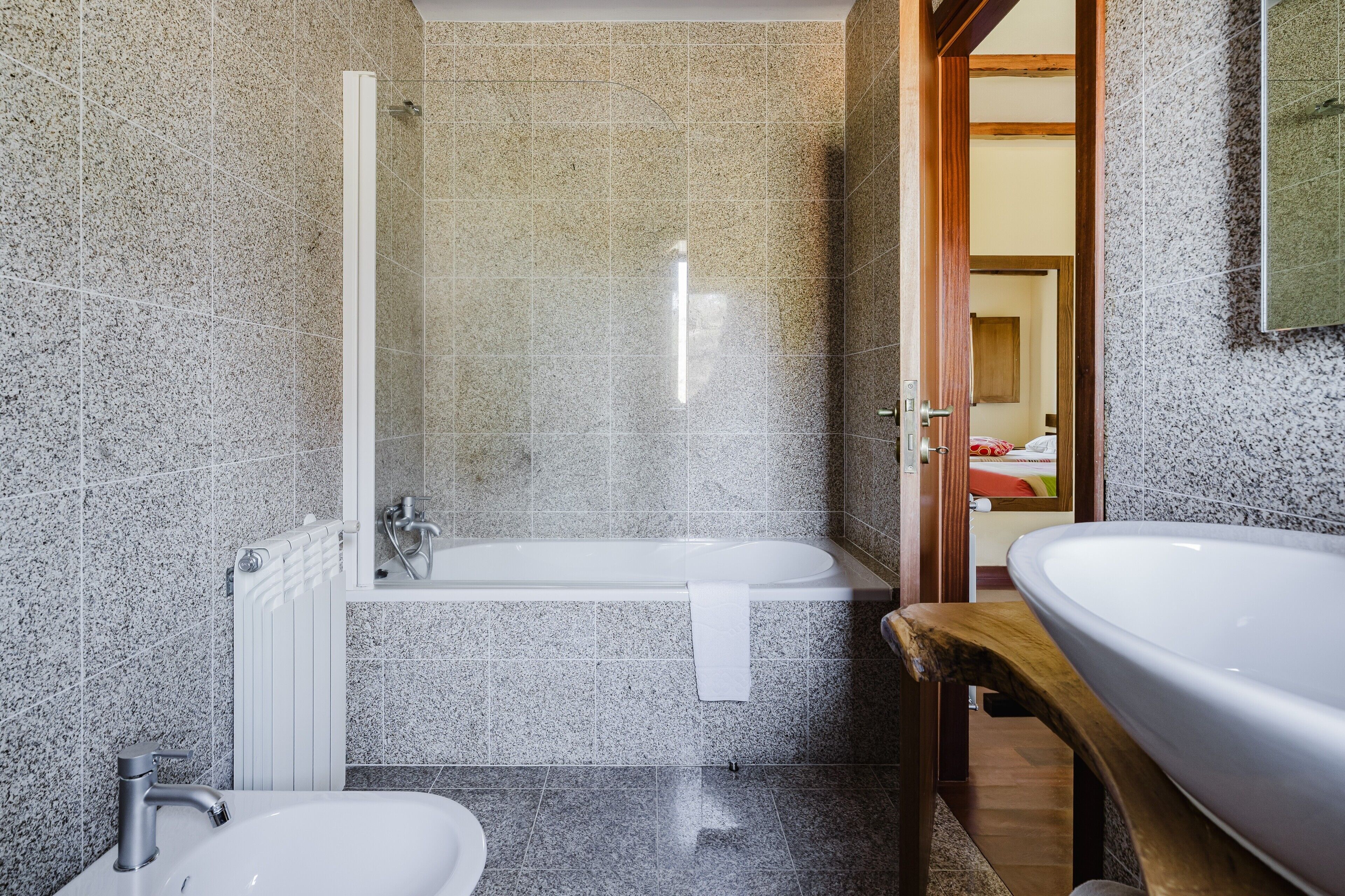 A bathroom with a bathtub, a sink, and a shower.