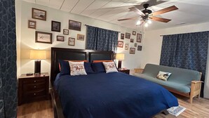 A bedroom with a large bed, two bedside tables with lamps, a ceiling fan, and a sofa. - Rodeo Ranch: Shuffleboard, Near seasonal Live Rodeo, Bunkbed, King Bed, SMOOR (Mansfield)