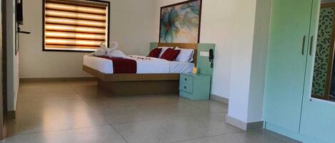A bedroom with a bed, bedside table, and a wardrobe.