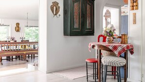 A dining area with a wooden table, red chairs, and a red and white checkered tablecloth. - Sjödrömmen by Interhome (Hudiksvall)