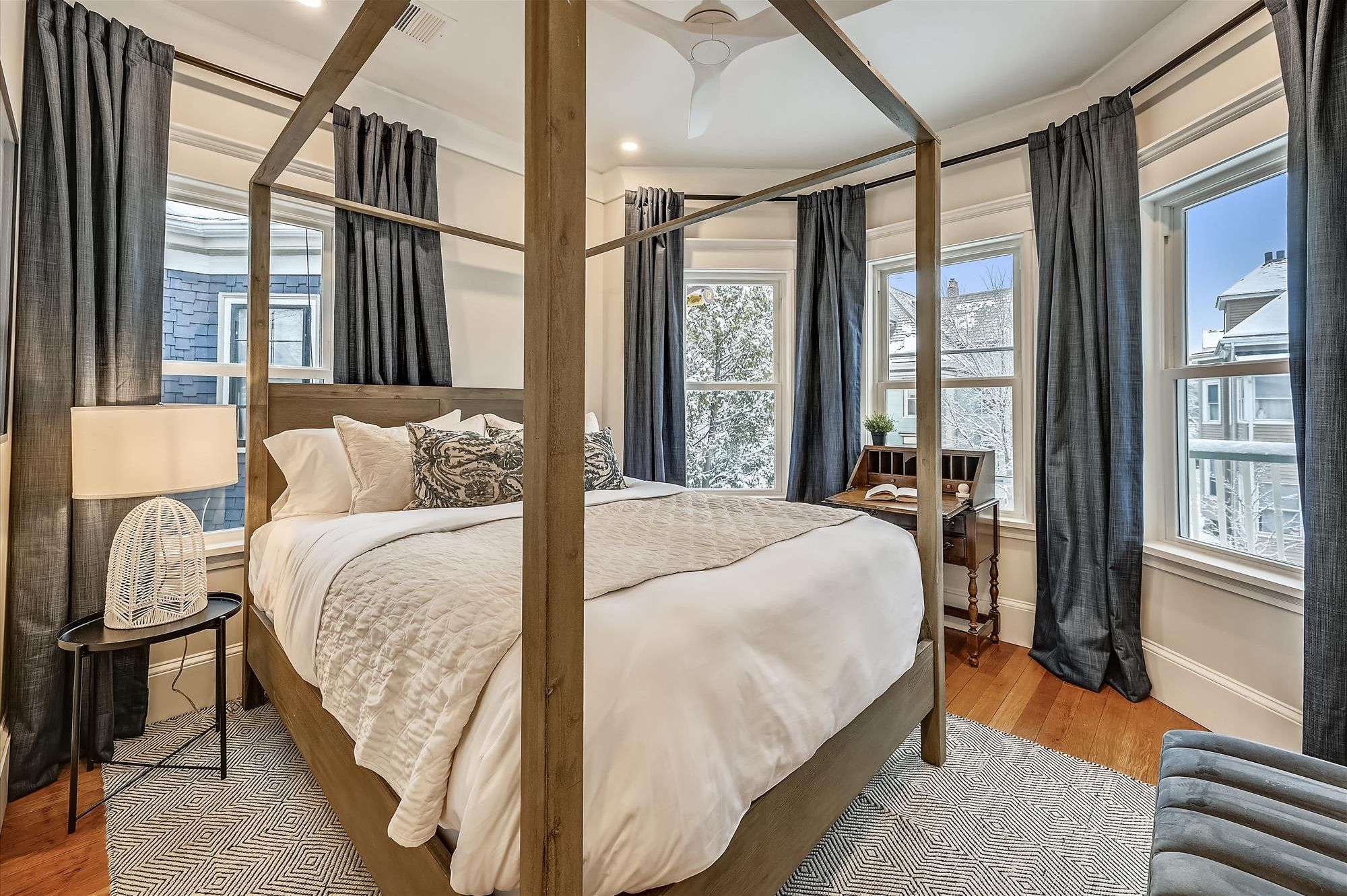 Bedroom 2 | Queen Canopy Bed with Ceiling Fan, Writing Desk, and Ensuite Access to Bathroom 2 | Unit 2 — Second Floor of Building — Two-Level Unit