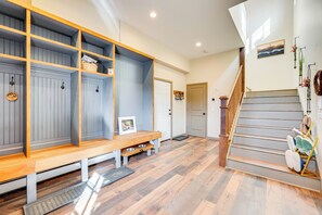 A hallway with a wooden bench, a dog bowl, and a staircase. - Pristine Cabin w/ Stables in Black Hawk by Casinos (Black Hawk)