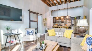 A modern living room with a sofa, coffee table, and a TV.