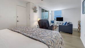 A bedroom with a bed, a desk, a chair, and a sofa. - STEPS TO BONITA BEACH | SLEEP NUMBER KING BED | IN-UNIT WASHER/DRYER | BEACH GEAR INCLUDED (Bonita Springs)