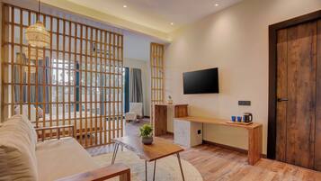 A modern living room with a sofa, coffee table, and TV.
