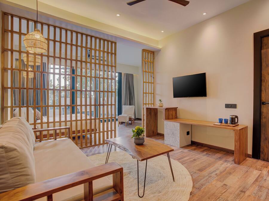 A modern living room with a sofa, coffee table, and TV.