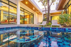 A modern pool area with a glass-tiled design, a wooden ceiling, and a seating area with a view of the pool. - Siena Villa Stunning 3BR&PrivatePoolV172 (Rawai)