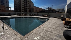 A rooftop swimming pool with a clear view of surrounding buildings. - The Mark Hotel  (Manama)