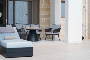 A modern outdoor seating area with a sofa, chairs, and a table. - Free heated pools & 800m sea (Kissamos)
