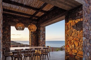 Enjoy al fresco dining with a view of the sea from this outdoor dining area.