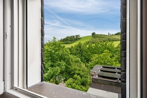 A window view of a lush green landscape with rolling hills and trees. - Holiday Home 'Maag, 102qm' with Private Terrace and Wi-Fi (Attendorn)