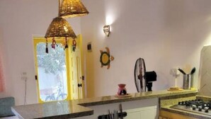 A compact kitchen with a small island, a gas stove, and a sink. - Sea shy apartment (Dahab)