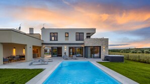 A modern two-story house with a swimming pool, outdoor seating, and a view of the countryside. - Vacation home Alba by Interhome (Novigrad (Istra))