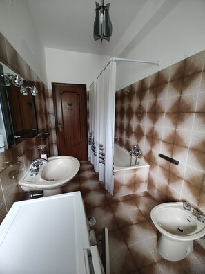 Bidet, towels, toilet paper