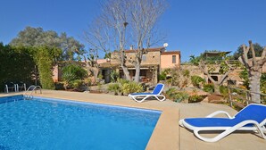 A swimming pool with two sun loungers and a clear blue sky. - Rafal baix - idyllic country house with private pool (Son Servera)