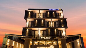 Ein mehrstöckiges Hotel mit Balkonen und einem gut sichtbaren Schild für Eastern Gate.