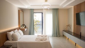 A hotel room with two beds, a TV, a balcony with a view, and a modern design. - Sylvana Hotel (Ayvacik)