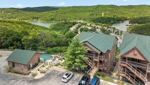 A lodge with multiple buildings, a swimming pool, and a river in the background.