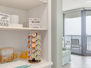 A kitchen with a sign saying "Kitchen Closed I'm at the Beach" and a coffee machine with various coffee pods. - Gulf-view Balcony: Beachfront Condo in Pcb! (Panama City Beach)